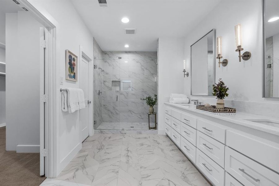 Bathroom featuring vanity and a shower with shower door