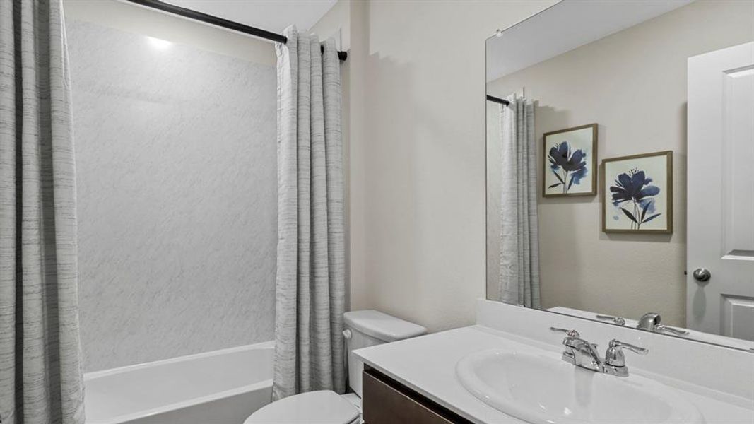 Bathroom featuring vanity and shower / bath combo