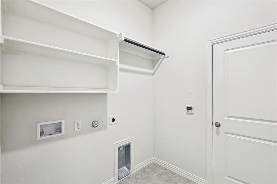 Washroom with hookup for a washing machine, gas dryer hookup, light tile patterned floors, and electric dryer hookup