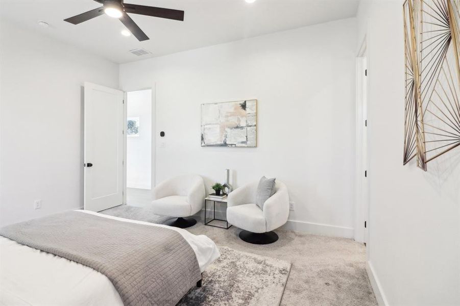 Carpeted bedroom with ceiling fan