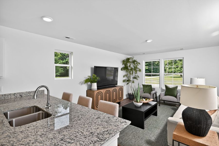 A living room with a large table and chairs.