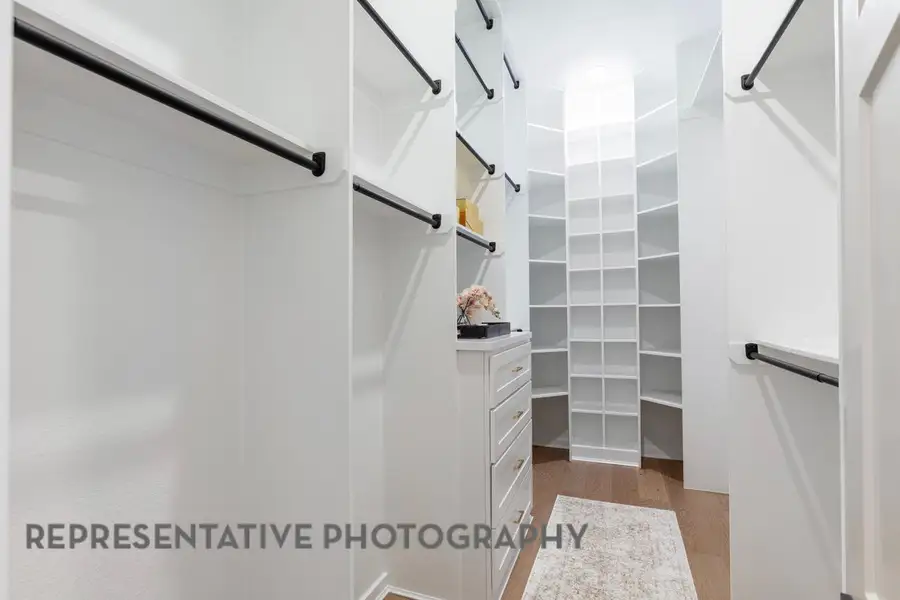Spacious closet with wood finished floors