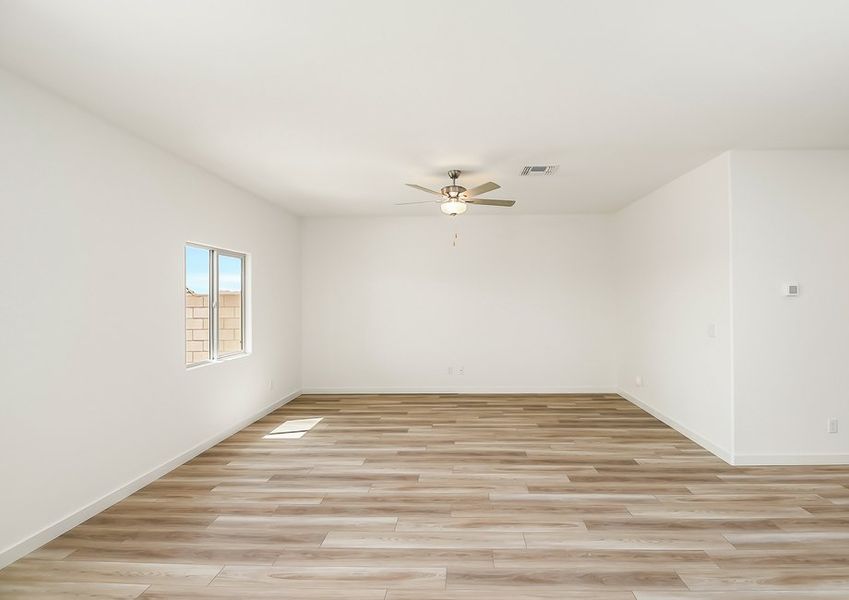 Family room with ceiling fan and vinyl flooring in Wellton floor plan