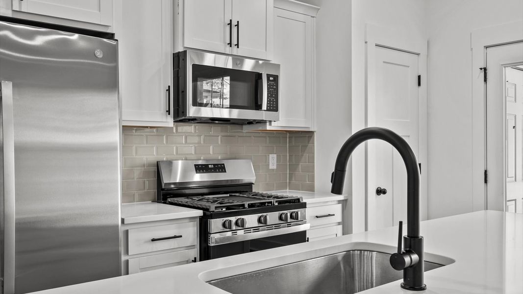 Elegant kitchen featuring a functional island and clean, current styling throughout