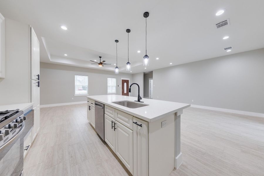 Kitchen island with built-in sink, offering additional workspace and a convenient focal point for meal prep and gatherings.