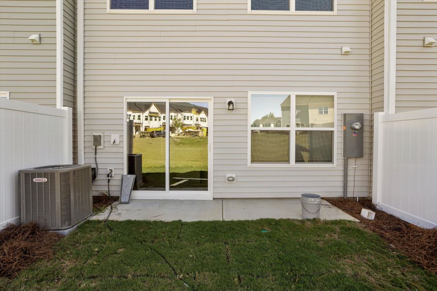 Exterior details and patio area of a home in West Main Townhomes, Sanford (Image 3).