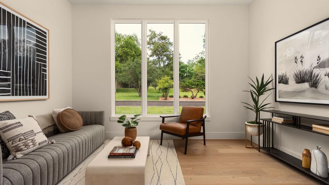 Hardwood floors and generous windows frame verdant outdoor views in this welcoming living space. Hardwood floors and generous windows frame verdant outdoor views in this welcoming living space.