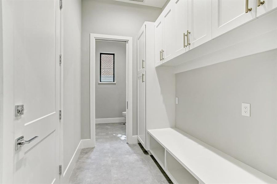 This convenient mud room can be entered from the garage or through the house and boosts of great cabinets, shelves and storage nooks.