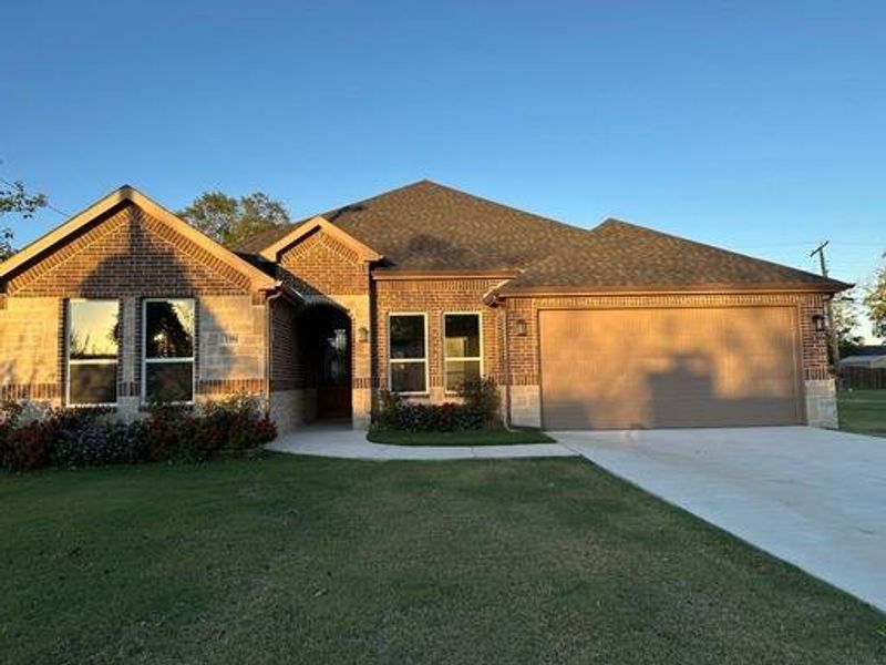 View of front of house with a front yard and a garage