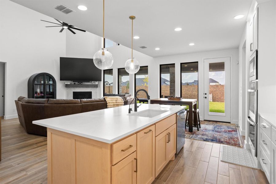 Kitchen opens seamlessly to living and dining spaces