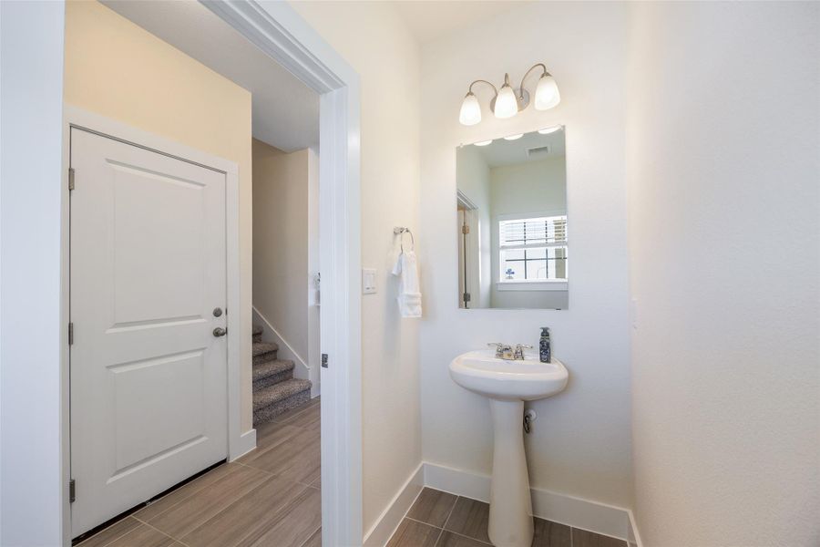 Half bath featuring baseboards and wood tiled floors Half bath featuring baseboards and wood tiled floors