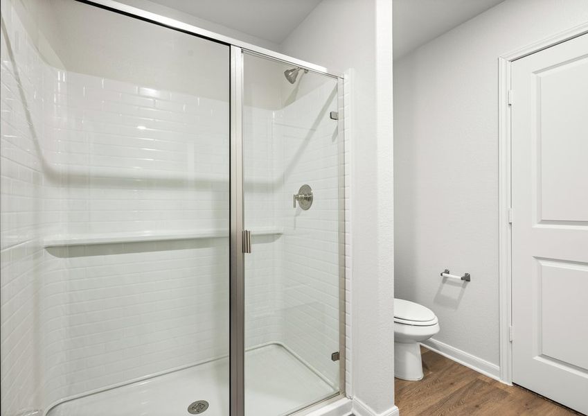 The master bathroom has a glass walk-in shower.