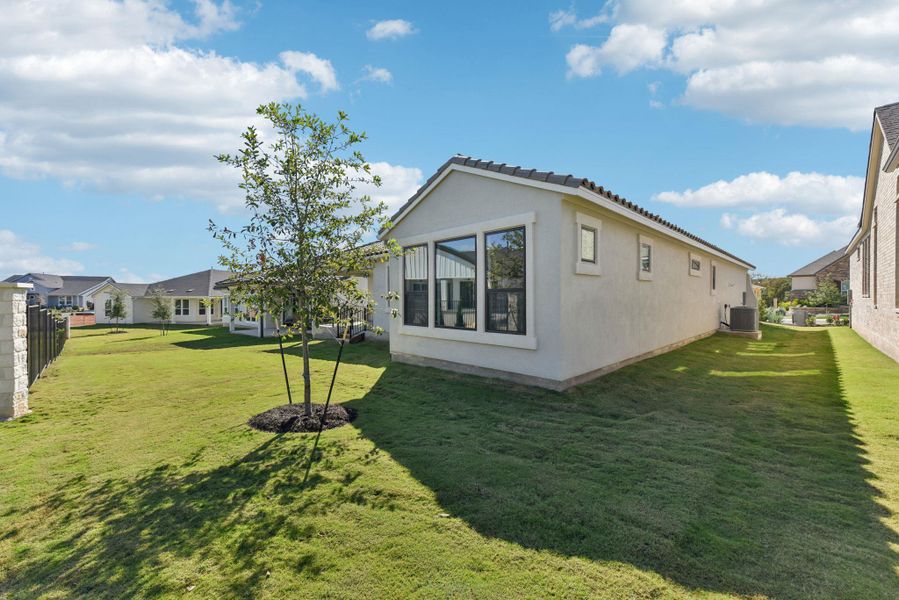 View of side of property with stucco siding and a tiled roof View of side of property with stucco siding and a tiled roof