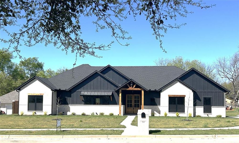 Front exterior of a new home in , Grandview, TX, highlighting curb appeal (Image 2). Front exterior of a new home in , Grandview, TX, highlighting curb appeal (Image 2).