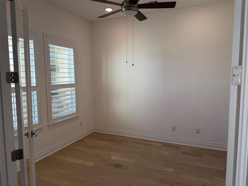 Lots of natural light, Plantation shutters, Glass French doors,  wood floors, recessed lighting, and ceiling fan