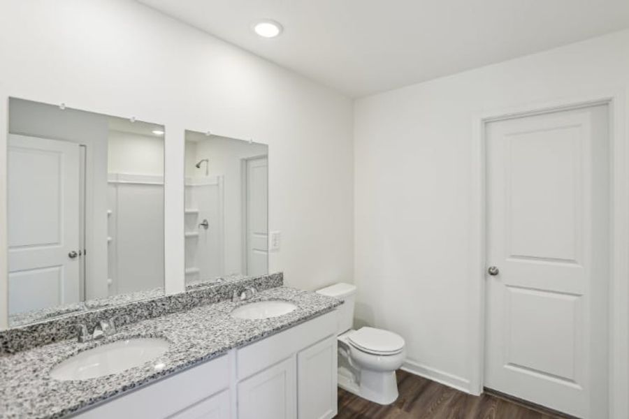A bathroom with a marble countertop.
