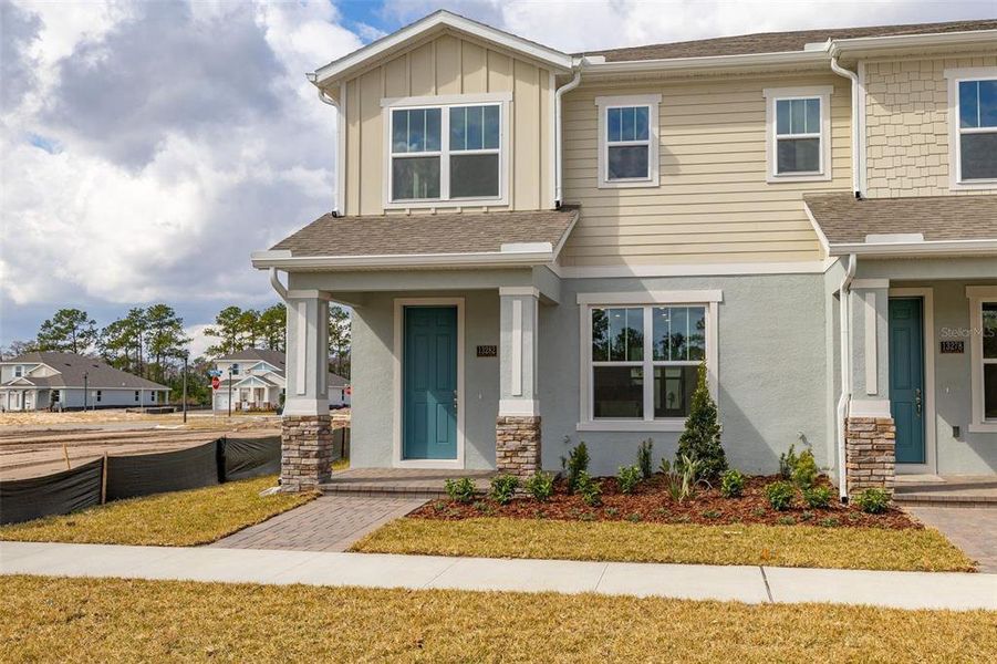 Front exterior of a new home in Serenade at Ovation, Winter Garden, FL, highlighting curb appeal (Image 1). Front exterior of a new home in Serenade at Ovation, Winter Garden, FL, highlighting curb appeal (Image 1).