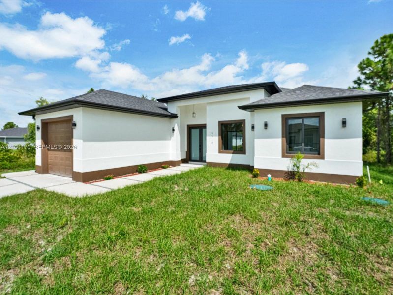 Front exterior of a new home in , Lehigh Acres, FL, highlighting curb appeal (Image 20). Front exterior of a new home in , Lehigh Acres, FL, highlighting curb appeal (Image 20).
