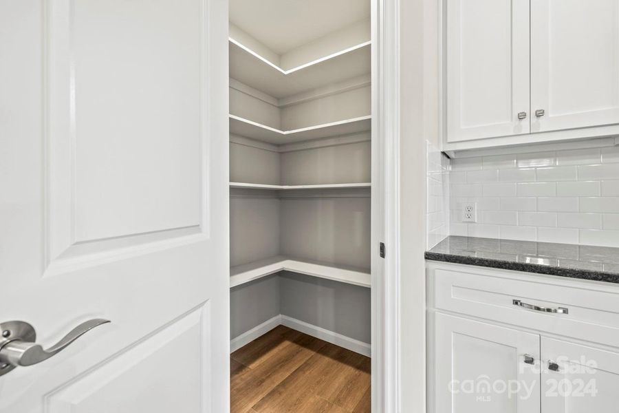 Pantry with custom wood shelves