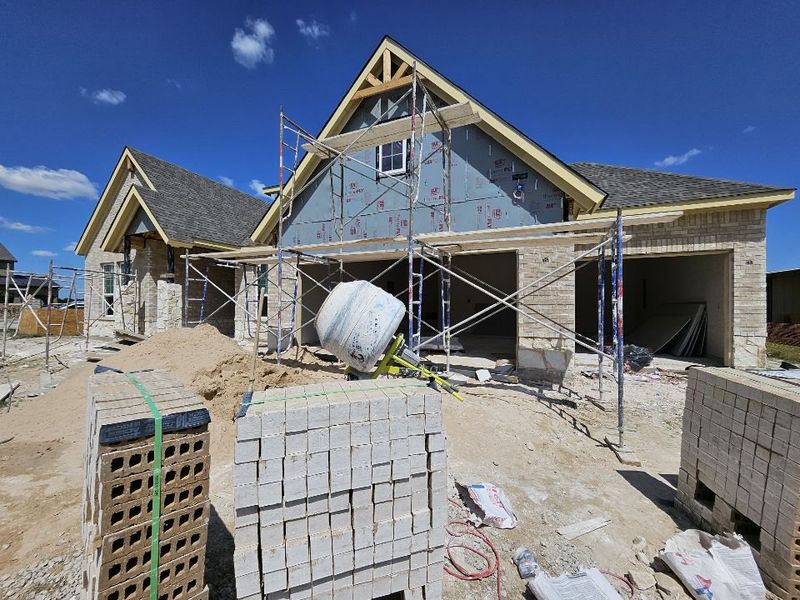 Front exterior of a new home in Aero Vista, Caddo Mills, TX, highlighting curb appeal (Image 10).