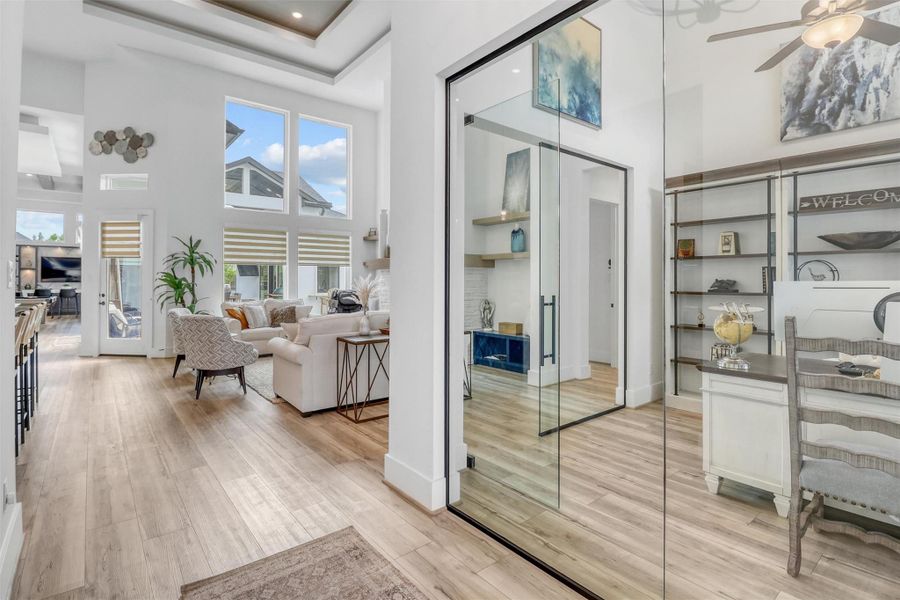 Welcome to modern luxury! Glass-enclosed office enhances the natural light emanating from all the windows. High ceilings with architectural detail abound, and wide plank flooring is beautifully done in a soft warm tone.