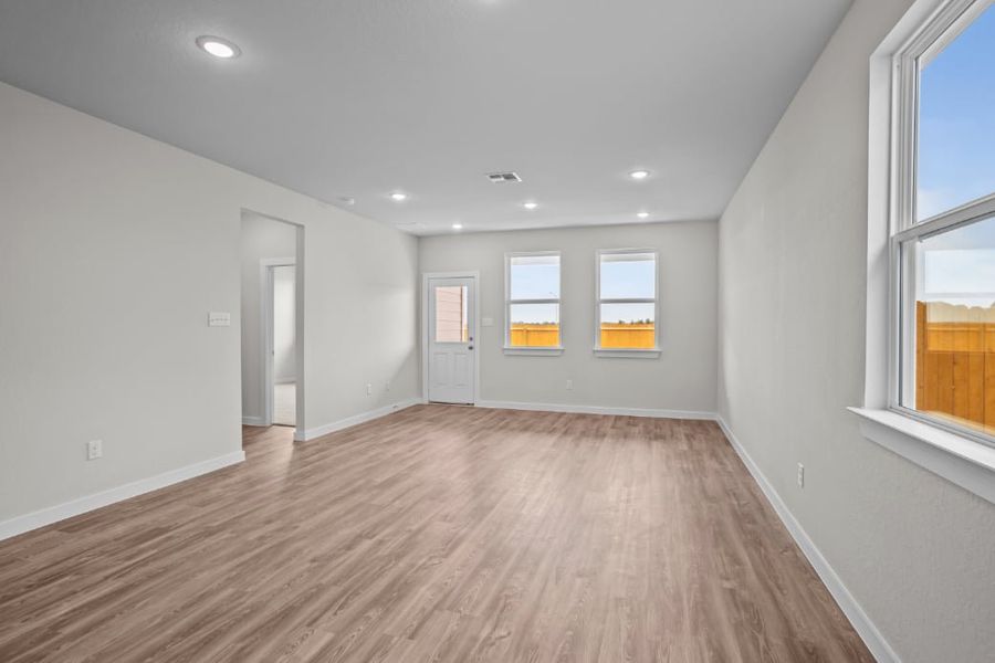 A room with a wood floor and windows. A room with a wood floor and windows.