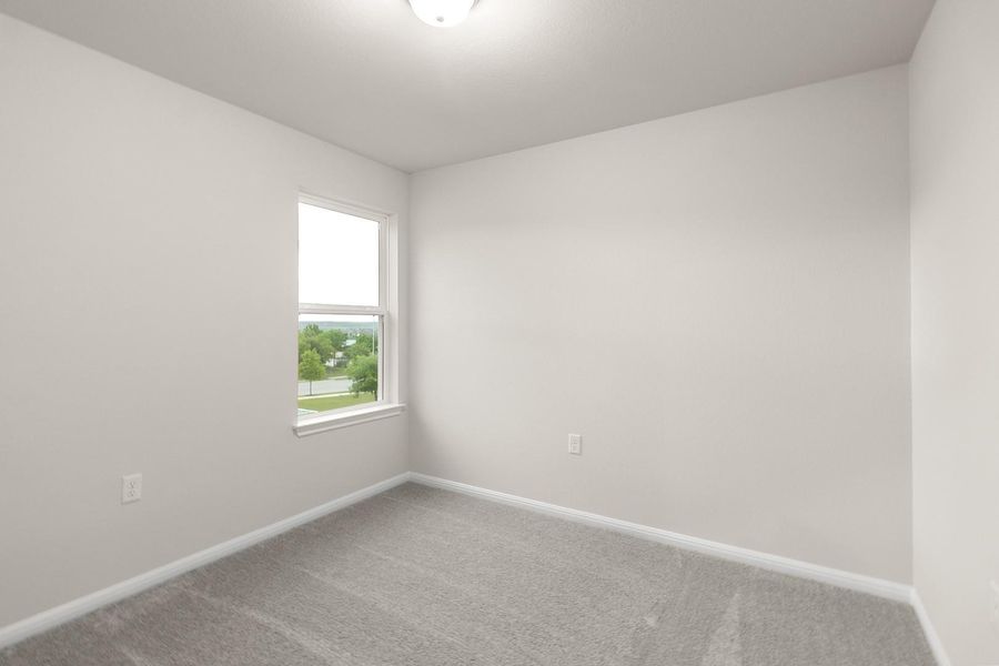 This room features light-colored walls and a window providing views of the surrounding landscape