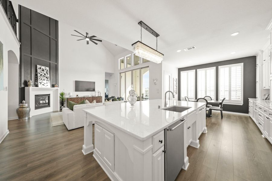 A view of the kitchen with views of the living room and breakfast area. This home is truly GORGEOUS!