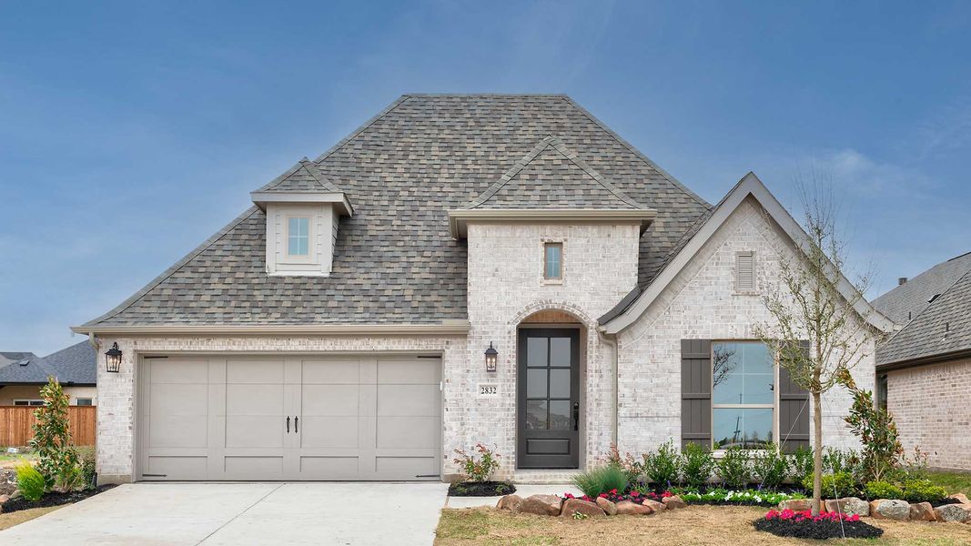 Front exterior of a new home in Cambridge Crossing, Celina, TX, highlighting curb appeal (Image 26).