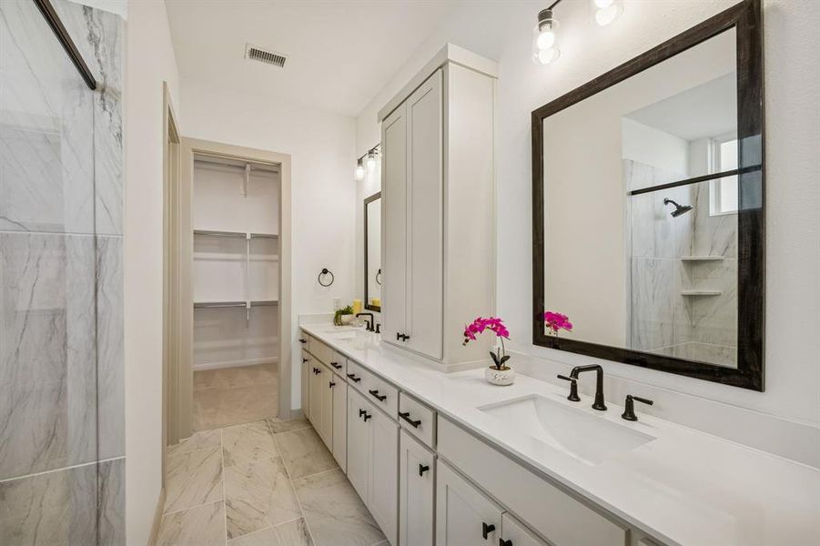 You'll enjoy ample space for two in this lovely owner's bath!