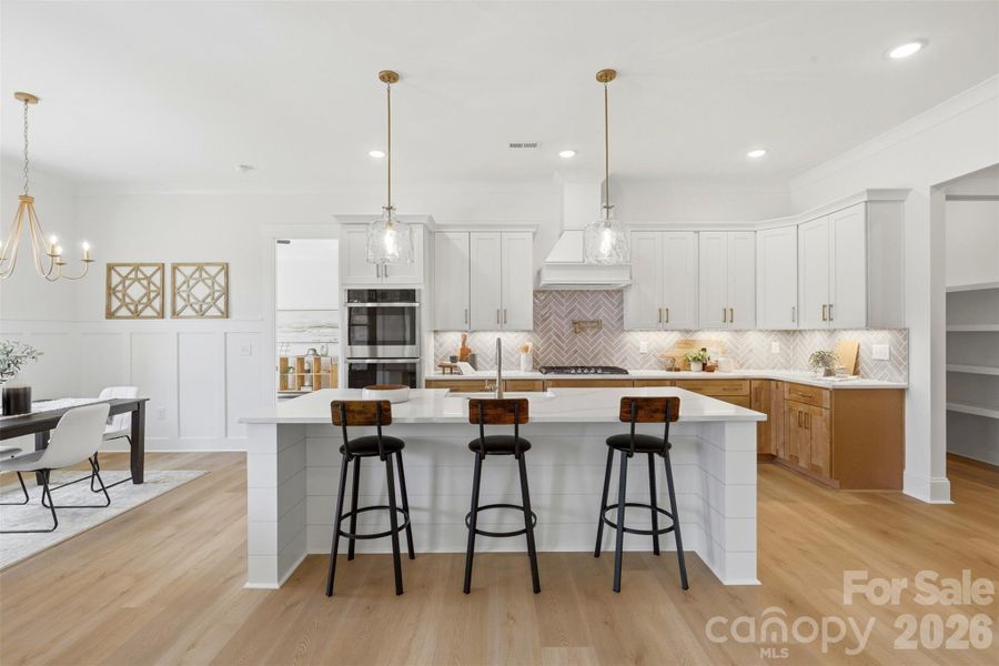 gourmet kitchen- custom  wood hood vent, porcelain farmmhouse sink, high quality quartz island, double oven, gas cooktop