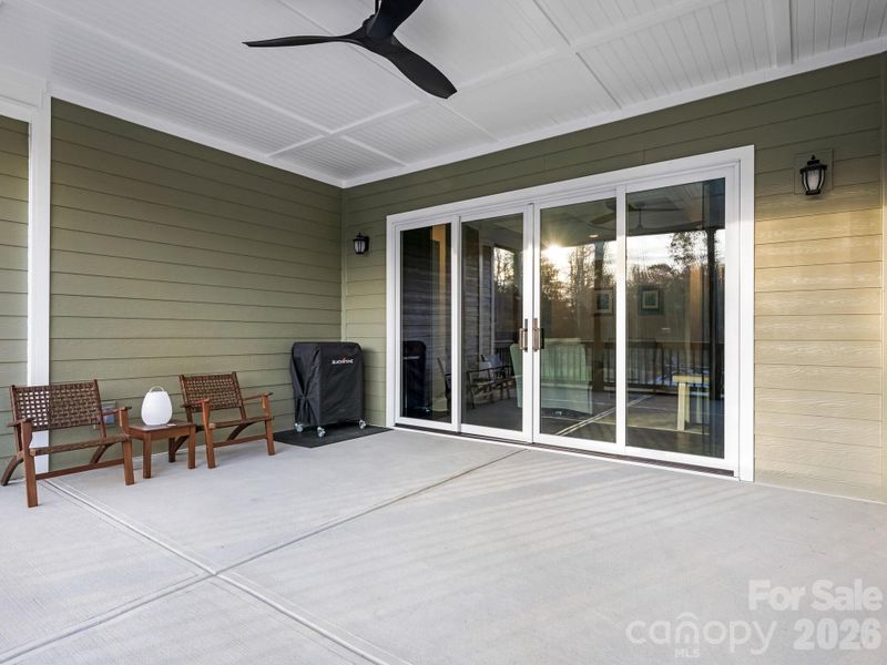 Screened-in porch, quad sliding doors, and ceiling fan