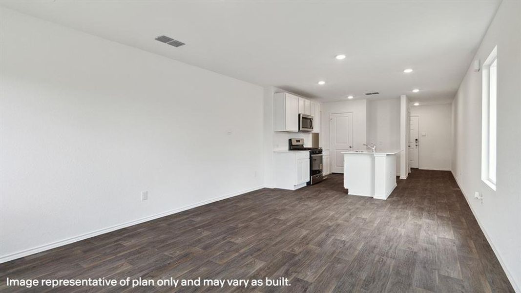 Unfurnished living room with recessed lighting and dark wood-style floors