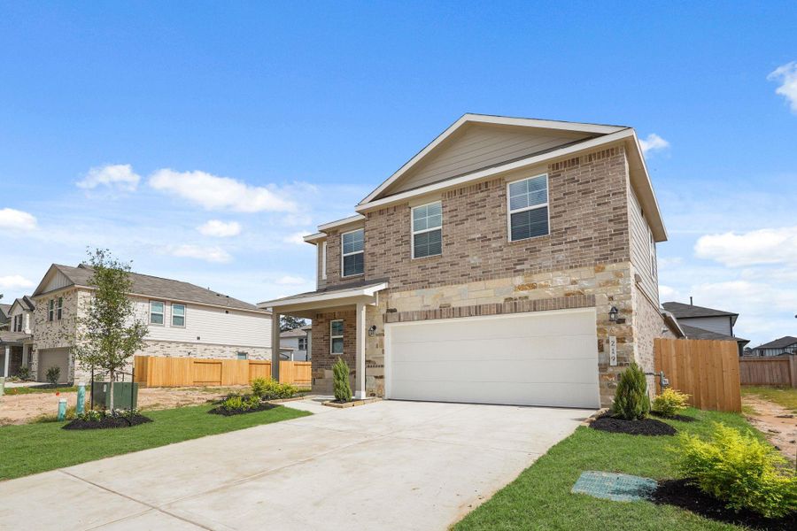 Front exterior of a new home in Lakes at Black Oak, Magnolia, TX, highlighting curb appeal (Image 2). Front exterior of a new home in Lakes at Black Oak, Magnolia, TX, highlighting curb appeal (Image 2).