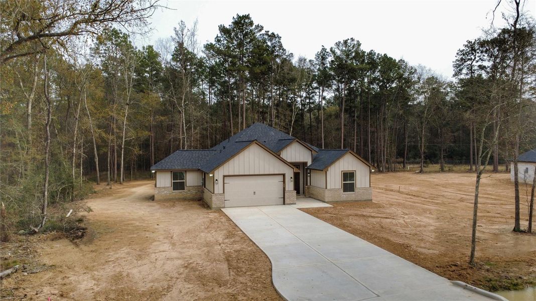 Front exterior of a new home in , Porter, TX, highlighting curb appeal (Image 24).