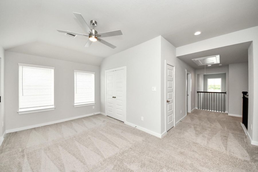 Come upstairs and enjoy a day of leisure in this fabulous game room! This is the perfect hangout spot or adult game room! Features plush carpet, high ceilings, custom paint and windows for plenty of natural light. Sample photo of completed home with similar floor plan. Actual colors and selections may vary. Come upstairs and enjoy a day of leisure in this fabulous game room! This is the perfect hangout spot or adult game room! Features plush carpet, high ceilings, custom paint and windows for plenty of natural light. Sample photo of completed home with similar floor plan. Actual colors and selections may vary.