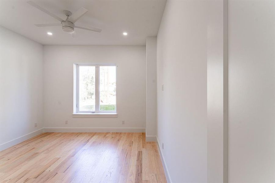 Unfurnished room featuring ceiling fan and light wood-type flooring