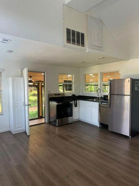 A compact kitchen with sleek appliances and durable flooring awaits your culinary touch.