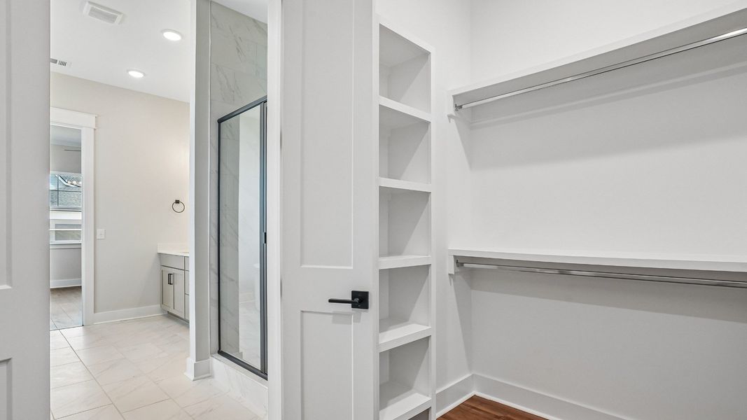 Primary Walk-in Closet with built-in MDF shelving