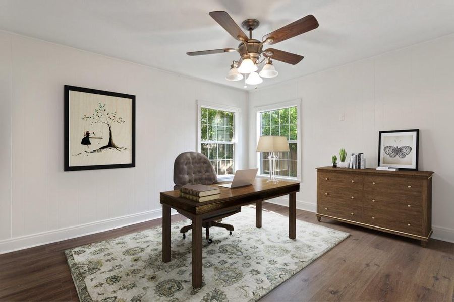 Home office featuring dark wood-type flooring, baseboards, ceiling fan, and ornamental molding