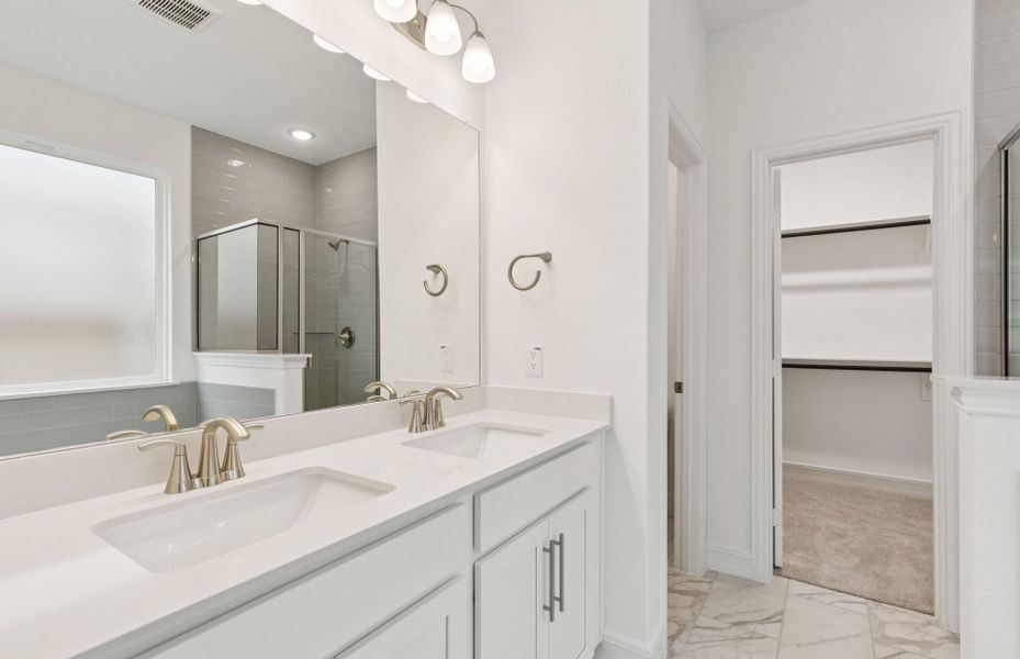 Owner's bath with double vanity and spacious shower  *Real home pictured