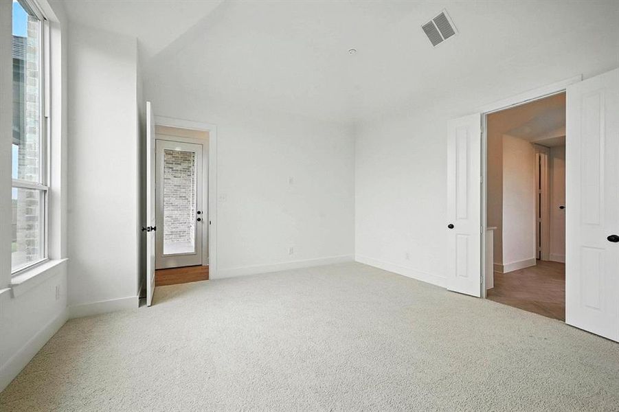 Unfurnished bedroom featuring light colored carpet and baseboards