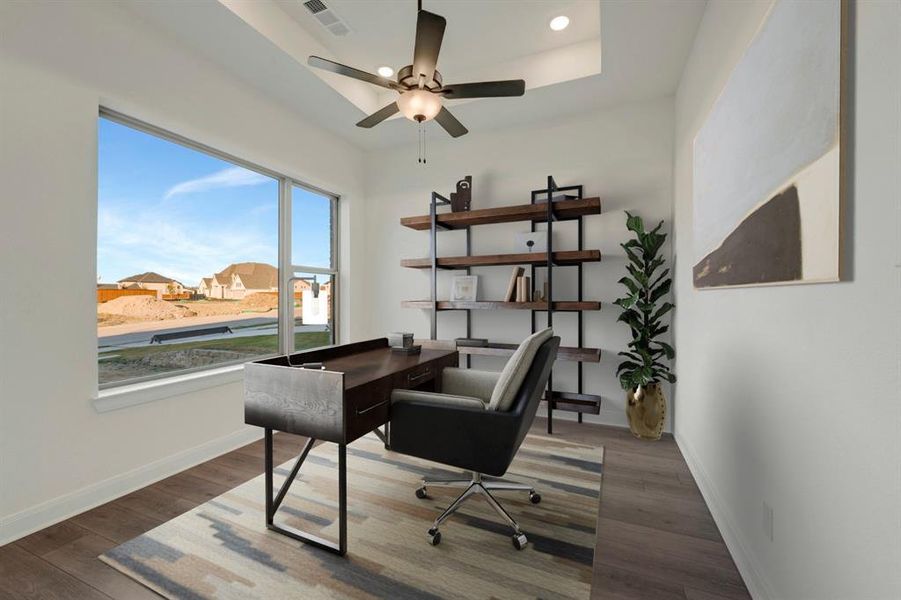 Office space with wood finished floors, a ceiling fan, a tray ceiling, and recessed lighting Office space with wood finished floors, a ceiling fan, a tray ceiling, and recessed lighting