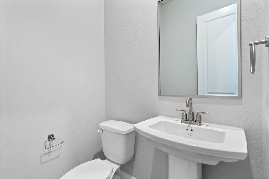 The powder bath features a stylish vanity and a clean, modern design.