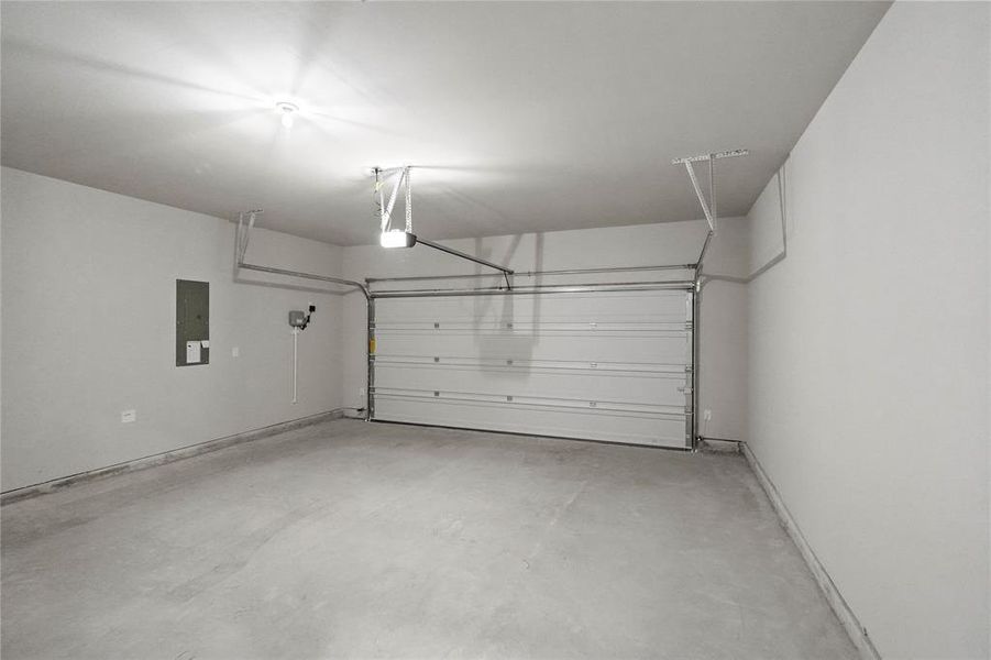 Garage with electric panel and a garage door opener