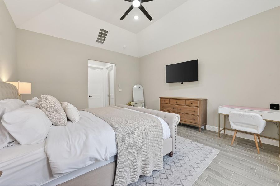 Primary bedroom view with private sitting area and media wall. Primary bedroom view with private sitting area and media wall.
