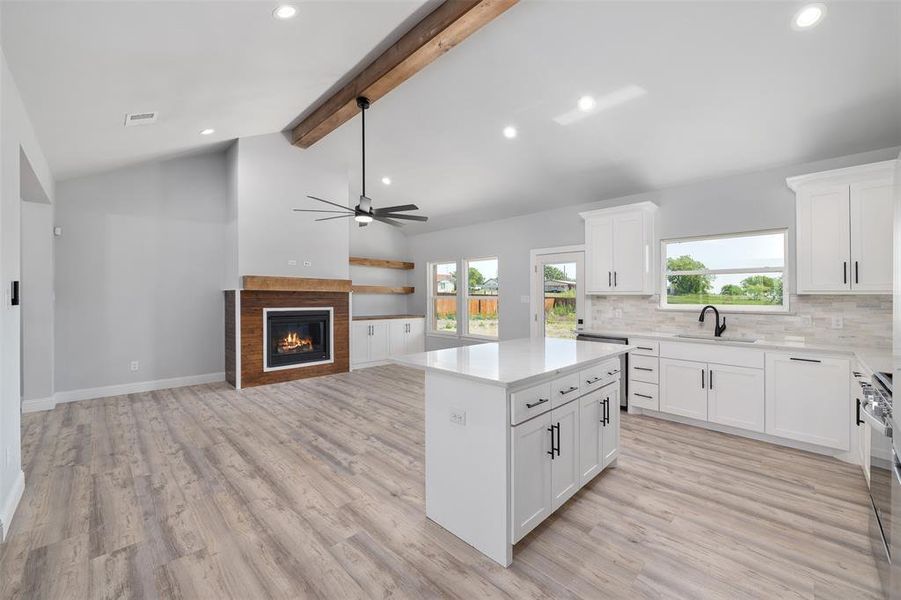 Kitchen with recessed lighting, plenty of natural light, light countertops, a ceiling fan, and a sink