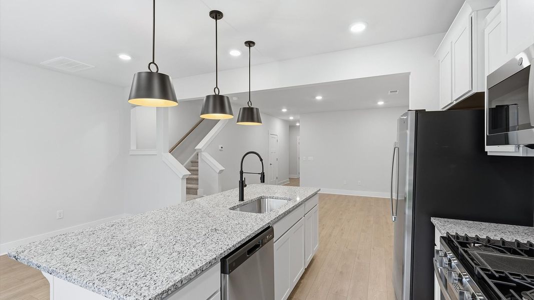 Bright and airy culinary space with generous prep areas and contemporary lighting at the Aspen Ridge community Bright and airy culinary space with generous prep areas and contemporary lighting at the Aspen Ridge community