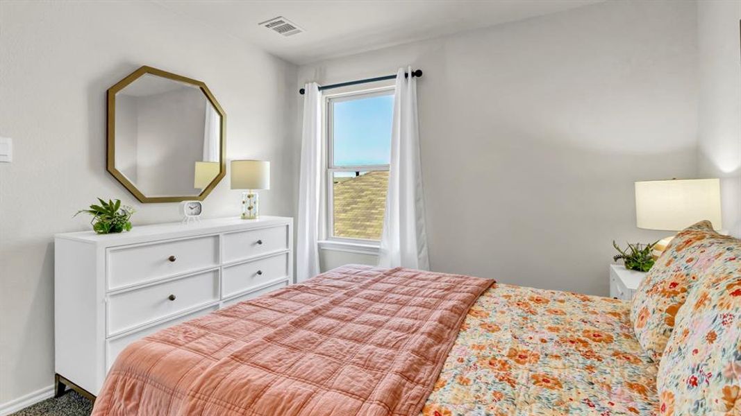 Bright room featuring a window with white curtains, white walls, and dark-framed window Bright room featuring a window with white curtains, white walls, and dark-framed window