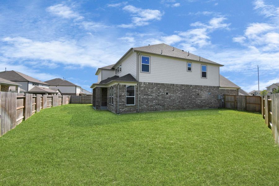 Explore the expansive backyard with its inviting covered patio—a perfect blend of space for the kids to play and adults to unwind. Ideal for creating your outdoor oasis, this backyard accommodates patio furniture, a BBQ pit, and endless possibilities for leisure and entertainment. Sample photo of completed home with similar floor plan. Actual colors and selections may vary. Explore the expansive backyard with its inviting covered patio—a perfect blend of space for the kids to play and adults to unwind. Ideal for creating your outdoor oasis, this backyard accommodates patio furniture, a BBQ pit, and endless possibilities for leisure and entertainment. Sample photo of completed home with similar floor plan. Actual colors and selections may vary.